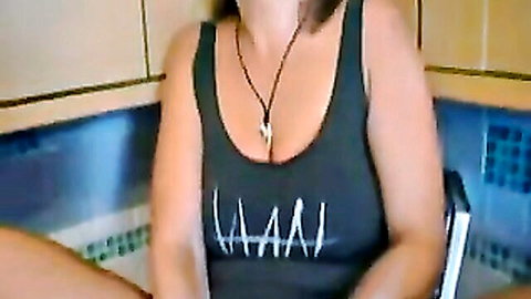 Sexy MILF in tight tank top showing deep cleavage in bathtub