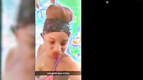 Sexy black woman in pink workout gear with hair bun
