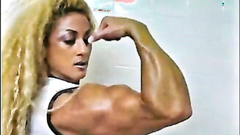 Mature muscle goddess flexing bicep in steamy bathroom tease