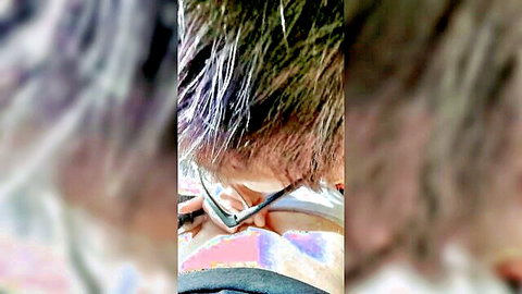 Blurry close-up of person with glasses and tube in neck during fetish blow scene
