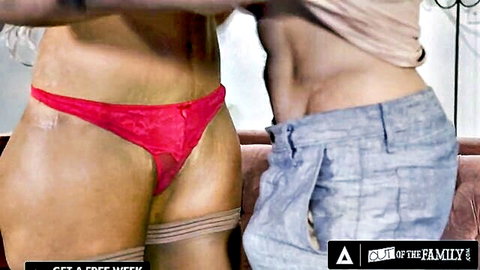Curvy MILF in sheer red lace thong and garters teasing beside muscular stud in gray pants