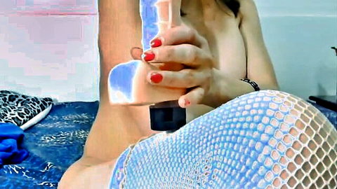 Hot mature Asian woman topless with blue dildo in fishnet stockings