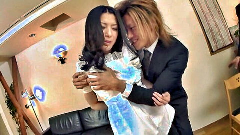 Suited Japanese man embraces busty Asian woman in shiny blue dress intimately