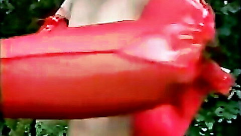 Chubby mature woman masturbating with red inflatable toys outdoors