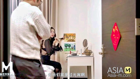Asian beauty in sheer black top with partner in intimate bedroom moment