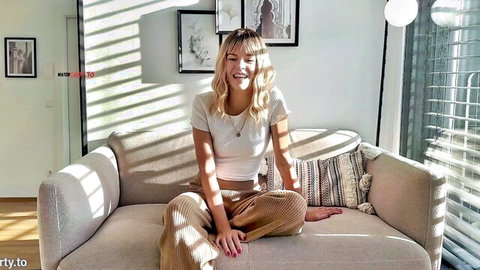 Blonde Arabella Spitz smiles casually in white top and pants, solo intro