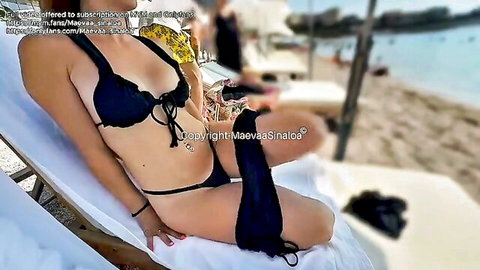 Curvy brunette in black lace bikini posing seductively on Monaco beach lounger