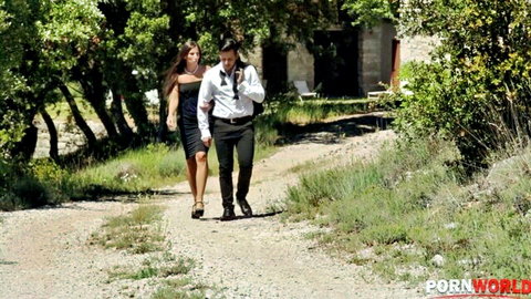 Clea Gaultier in black dress walks with man in outdoor wedding hookup scene