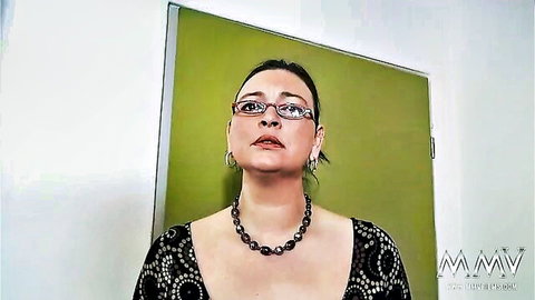 Chubby MILF in glasses for casting, black patterned dress and necklace
