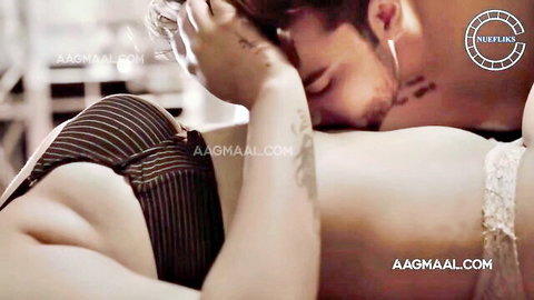 Indian couple in passionate neck kiss, woman in striped lingerie