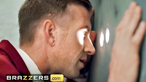 Blonde man in red jacket peeks through holes in wall for gloryhole cock sucking action