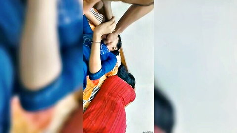 Indian women in blue and red dresses in intimate threesome touch