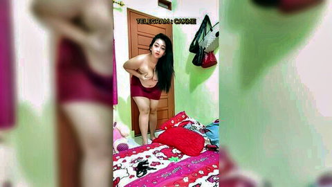 Topless Asian amateur babe with huge tits poses in red mini skirt showing bare ass cheeks