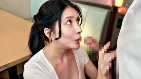 Asian woman in ponytail and white top giving censored blowjob in bar