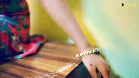 Tamil woman in vibrant saree teases with henna hand and bracelet, Khidki E02