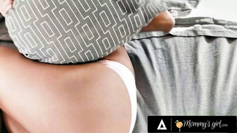 Tanned girl's bare ass exposed with white thong pulled aside on bed