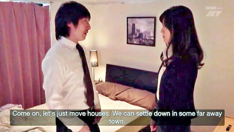 Japanese man in suit talking closely to brunette woman in blazer in bedroom