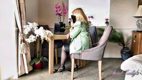 Busty British GILF Katie Wish in green coat on phone sex call at office