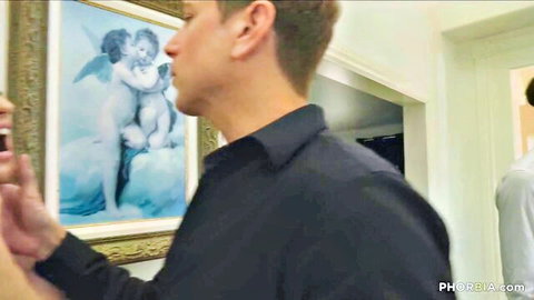 Two fit men in intimate face-touch in bisexual groupsex scene with angelic backdrop