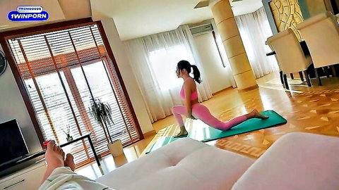 Fit stepsister in pink yoga outfit doing poses, watched by stepbrother
