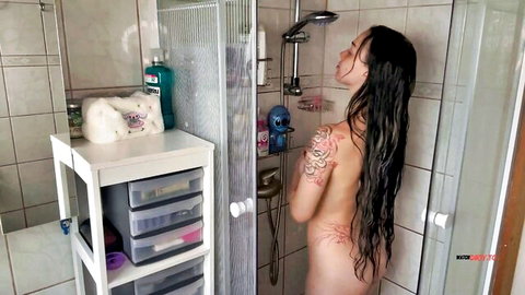 Cassandra Clasen nude in steamy shower, wet black hair and tattoos