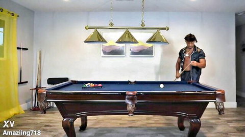 Muscular black hunk Gemini in leather bending over pool table
