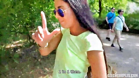 Amateur brunette gesturing outdoors with men in park, couple swap tease
