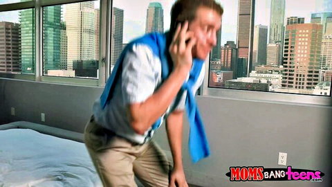 Fit Caucasian man on phone in hotel room, towel over shoulder, teasing reveal