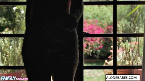 Lucky Anne teasing by window in sexy dark dress, curvy silhouette