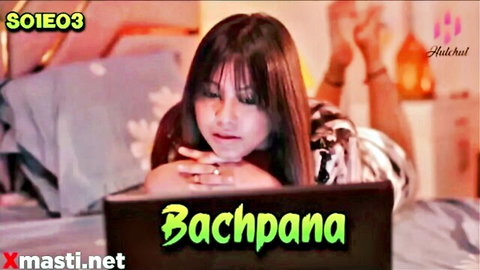 Seductive Indian woman with long dark hair leans on bed viewing laptop in Bachpanapana S01E03