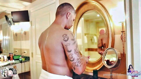 Tattooed black hunk in towel with Mz. Dani in mirror, steamy bath