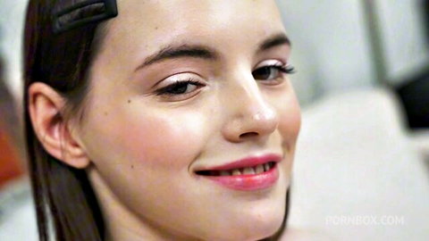 Dakota Doll's seductive close-up smile with glossy lips