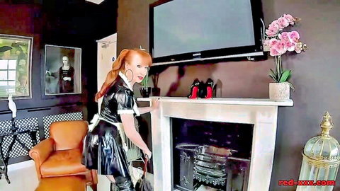 Redhead in shiny black latex maid outfit dusting fireplace bending over teasing curves