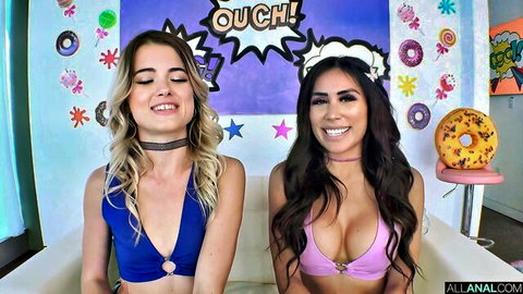 Busty blonde and brunette smiling with huge tits spilling from skimpy bikinis in candy room