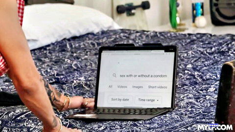Jesse Pony in red top on bed, laptop search for sex without condom