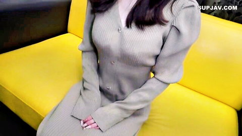 Petite former idol in gray knit dress with deep cleavage