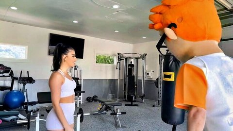 Gal Ritchie busty trainer in sexy gym pose with mascot costume