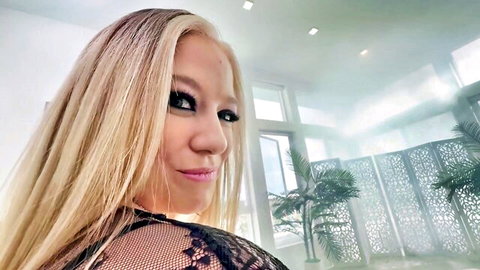 River Lynn in seductive black lace lingerie, blonde bombshell profile view
