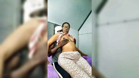 Ebony woman with big tits groped by black guy hands from behind on his lap