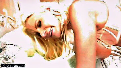 Blonde hotwife in white lingerie, smiling seductively with big tits exposed