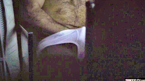 Hairy man pulls white underwear aside exposing thick erect cock in car seat