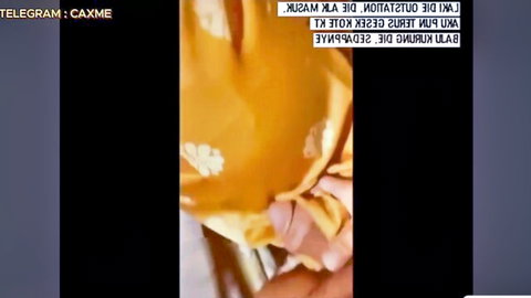 Malaysian amateur babe in orange polka-dot top teasing massive cleavage in homemade selfie