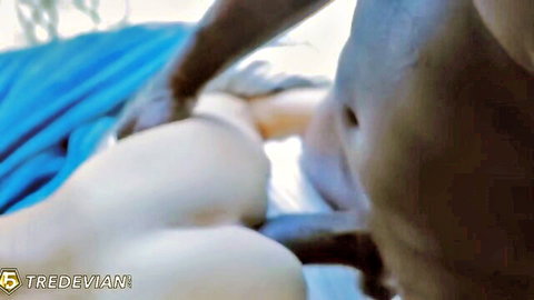 Black hand fingers spread shaved white pussy of horny woman on blue bed interracial amateur