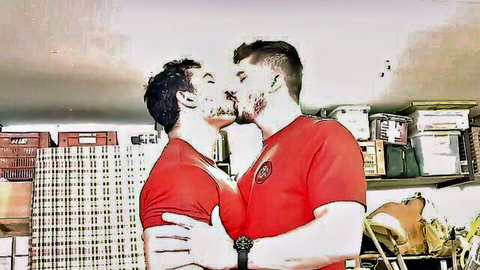 Two muscular men in red jerseys passionately kissing and embracing in a garage