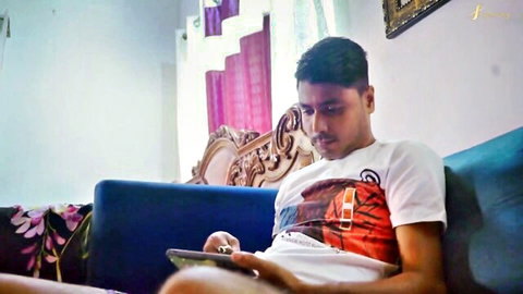 Young Indian stepson lounging, watching porn on tablet in taboo setup