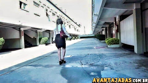 Sexy long-haired brunette in short skirt and high heels walks away teasing ass in parking garage