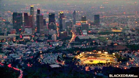 Stunning nighttime Los Angeles skyline with illuminated Dodger Stadium and city lights