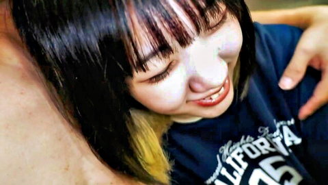 Smiling petite Asian girl in blue California tee hugged from behind