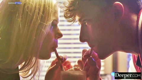 Blonde babe and stud intimately sucking straws from same glass in teasing foreplay.