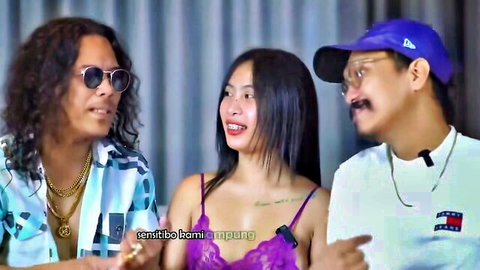 Smiling Asian woman in skimpy purple top showing cleavage between two grinning guys